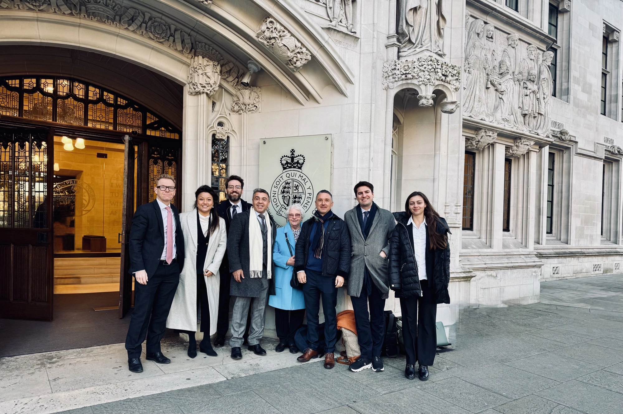 A group of people standing in front of a building